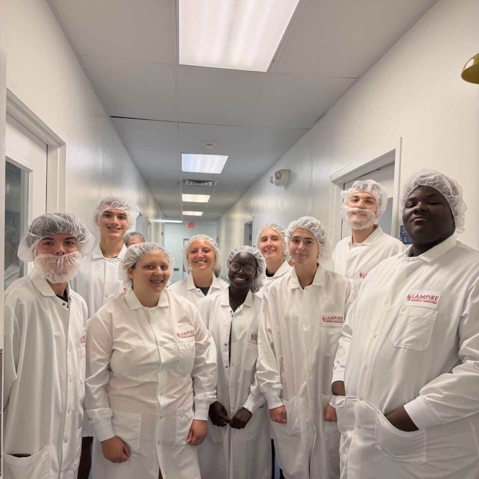 group of students posing with lab coats and hairnets