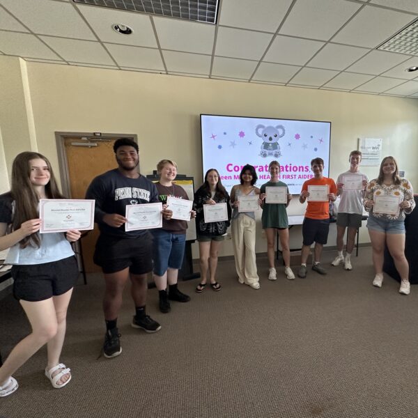Students posing with their Teen Mental Health First Aid certificates.