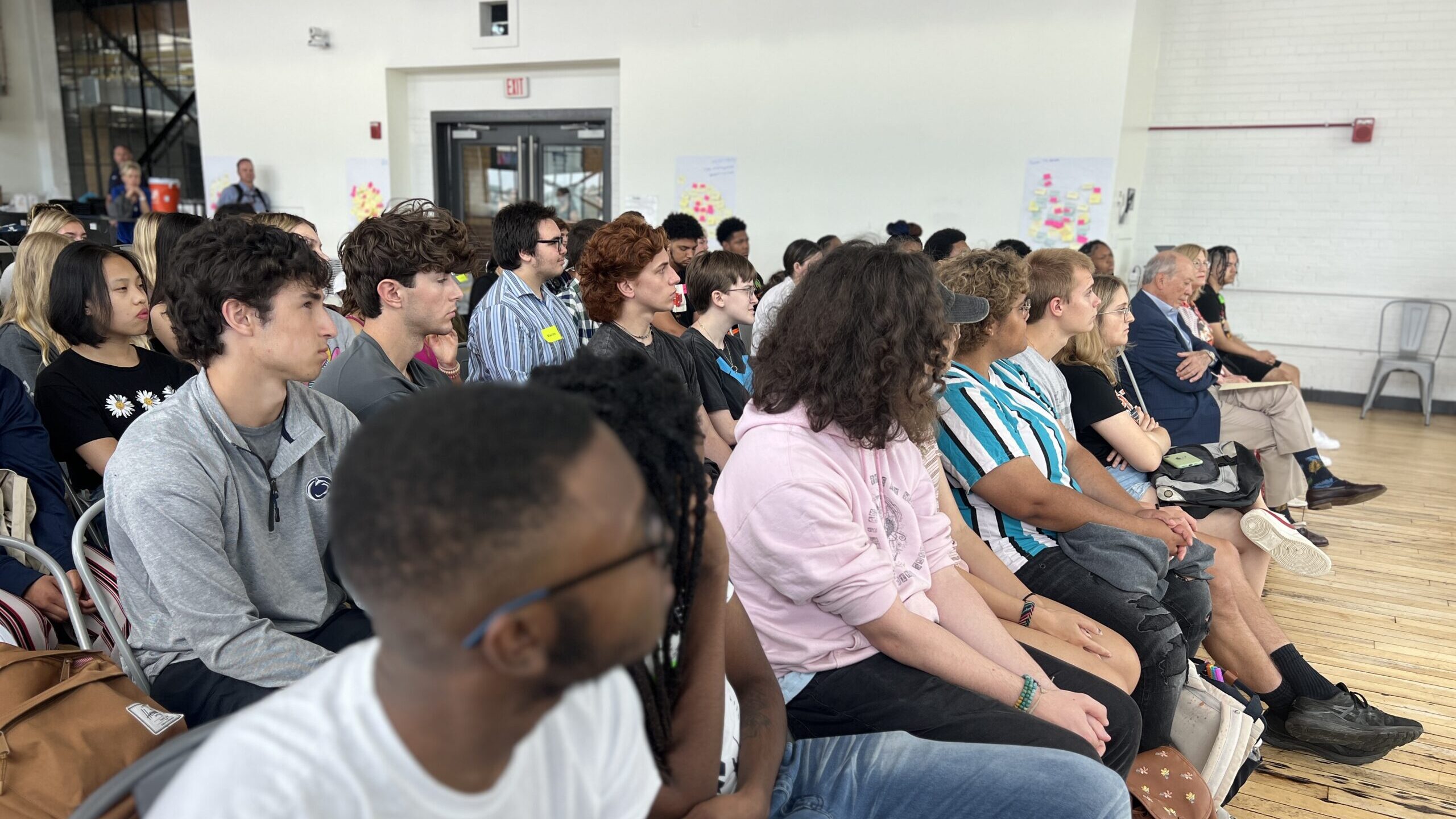 Learners in the Readiness Institute Summer Program listen to a speaker at the kickoff event