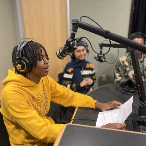 Students talking in microphones in the SLB Radio studio