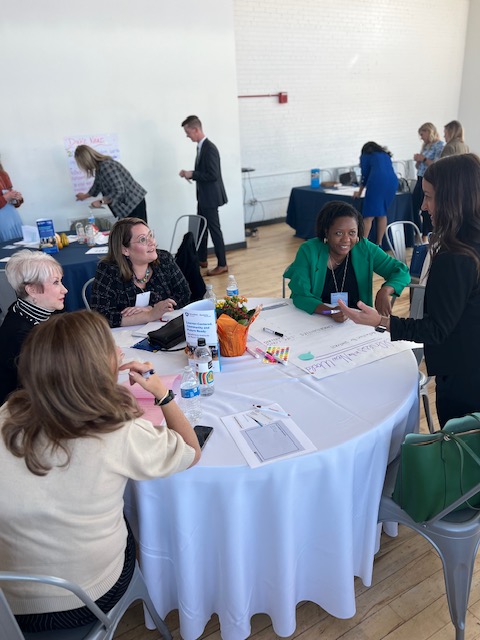 Attendees at the Readiness Institute Summit have a discussion around a table