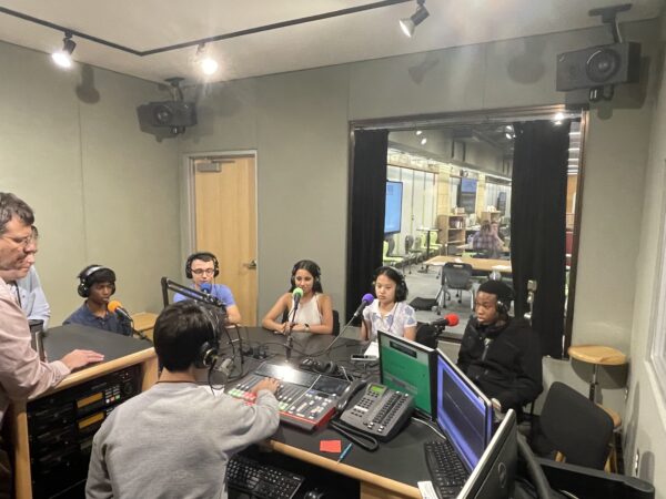 Learners in the Pittsburgh cohort of the Summer Program sit in the radio studio to record their own  Saturday Light Brigade podcast