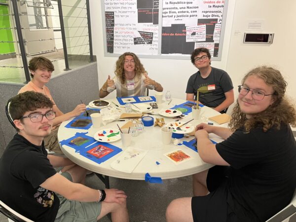 students around table with art