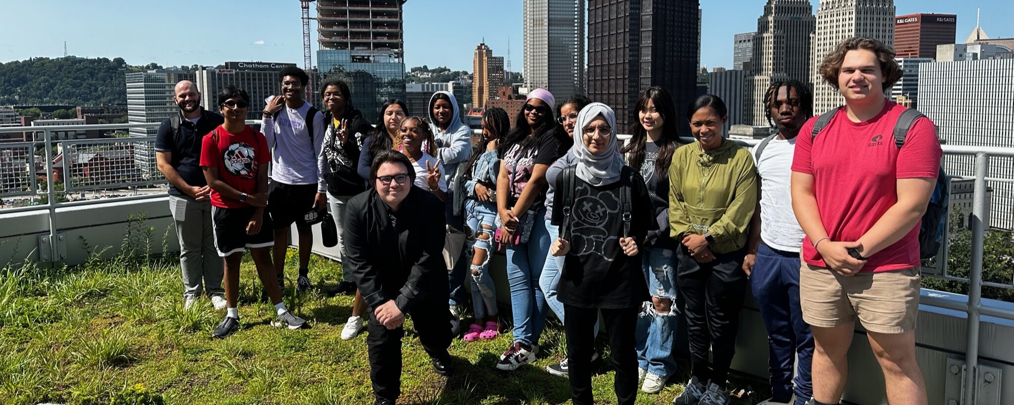 Group of students with the Pittsburgh city skyline behind them