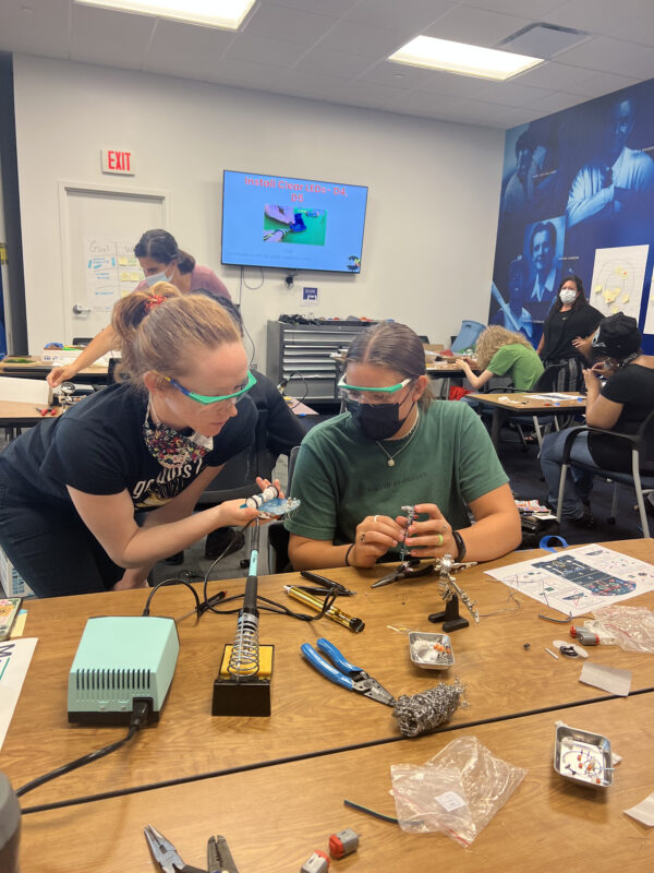 Student learns soldering with an adult mentor