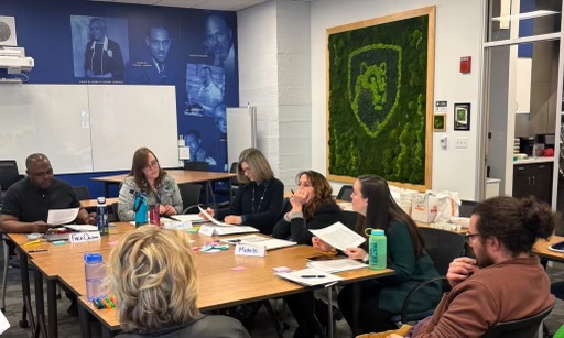 A group of educators sit at a table during a workshop