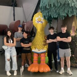 Students pose with a statue of Big Bird from Sesame Street