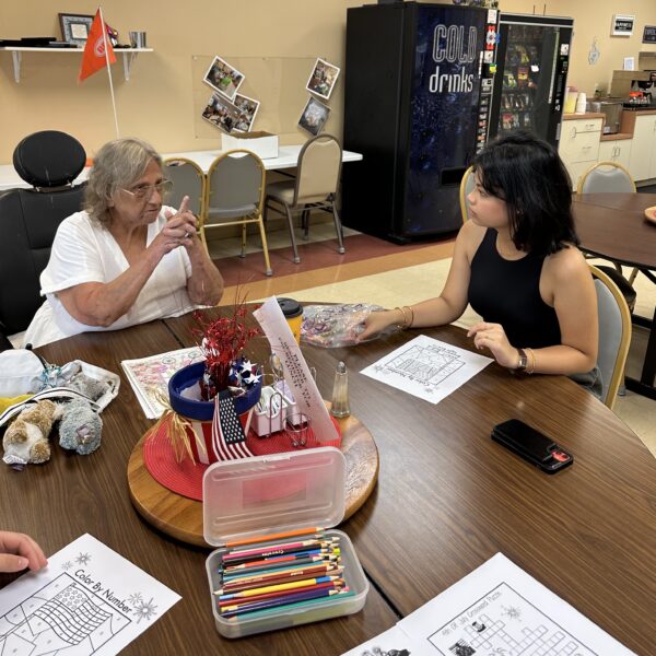 A student meets with a senior citizen.