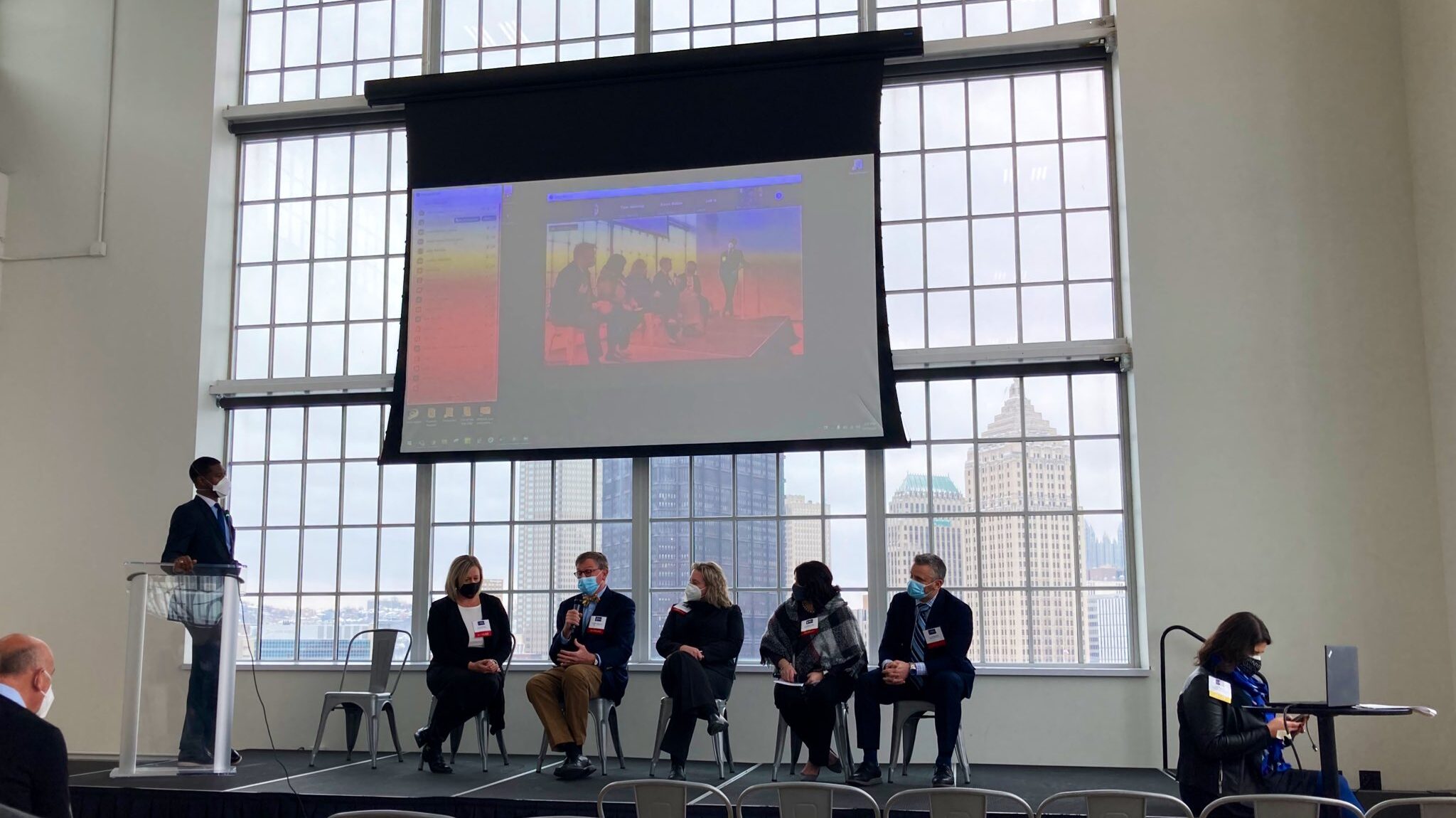 Presenters sit on stage during TRETC at the Energy Innovation Center