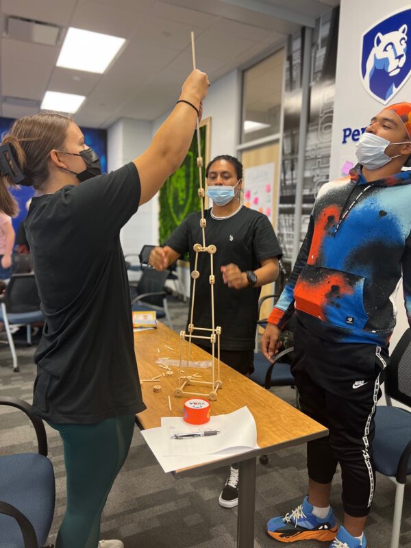 Students work as a team on a tower building exercise