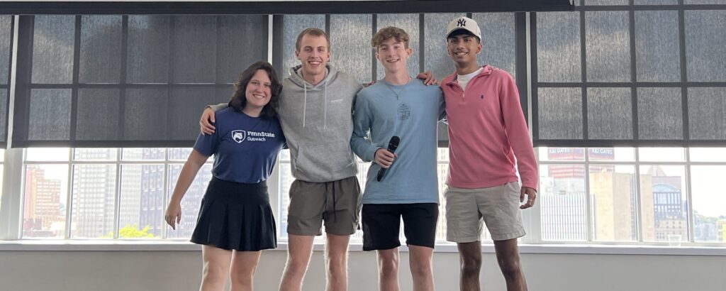 Four high school students with a microphone