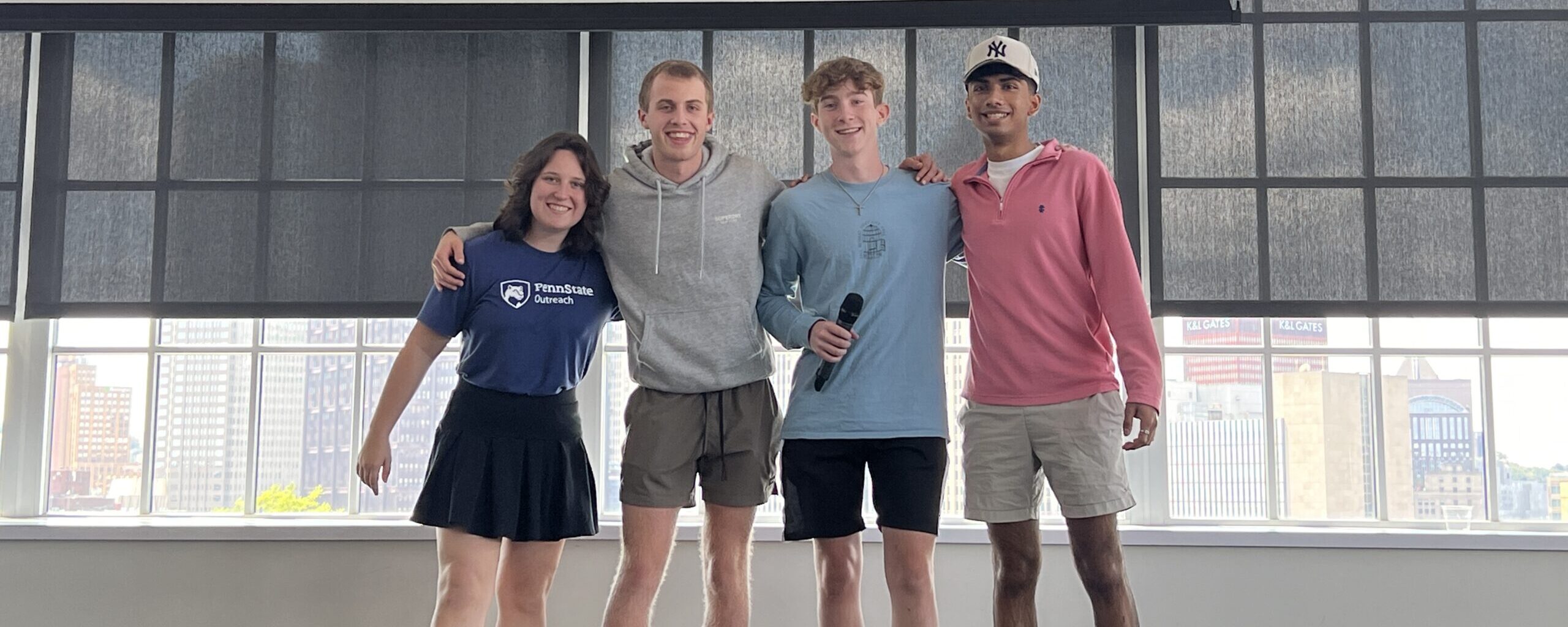 Four high school students with a microphone