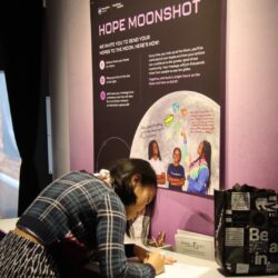 girl writing hope at Moonshot Museum 