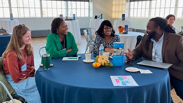 Summit participants having a discussion at a round table